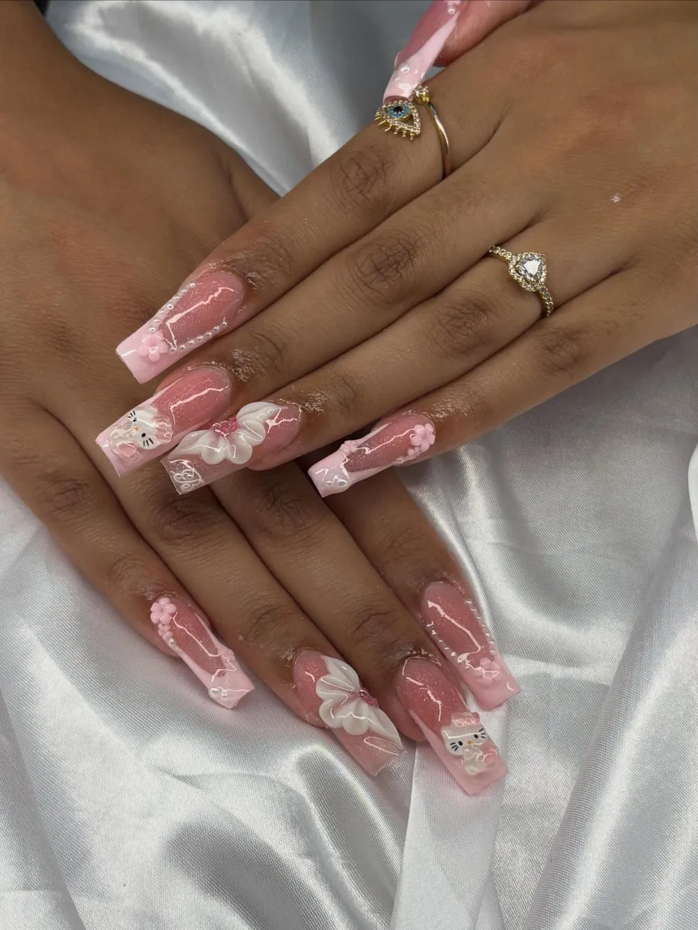 Pink acrylic nails with 3D flowers